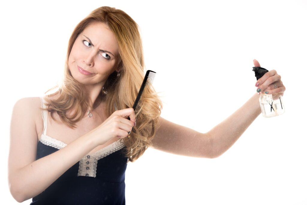 Young woman cutting her hair the woman